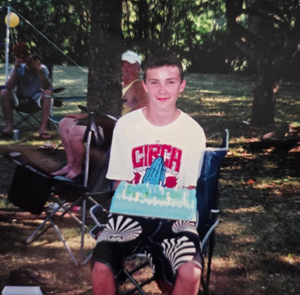 Brayden as a boy with a birthday cake